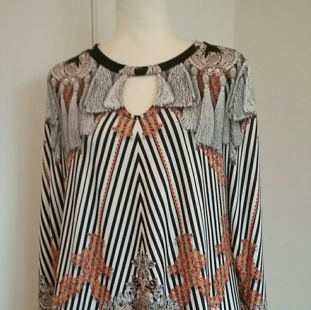 Super cute tassel and gold accents on this shirt.